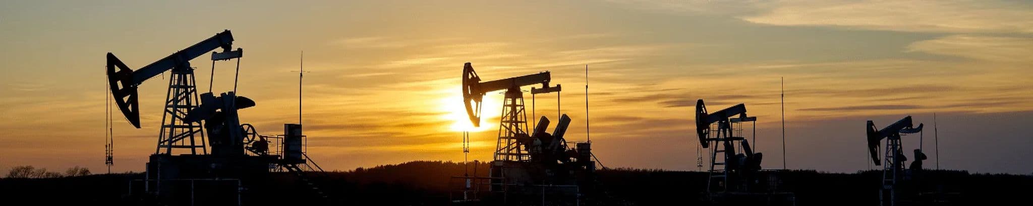 Oil pump jacks silhouetted against an Oklahoma sunset